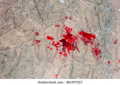 shattered glass on the floor with blood