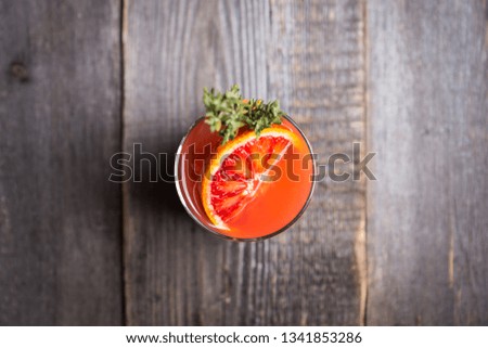 Bloody oranges beverage with thyme. Selective focus. Shallow depth of field.
