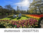 Blooming tulips flowerbed in Keukenhof flower garden, also known as the Garden of Europe, one of the world largest flower gardens and popular tourist attraction. Lisse, the Netherlands.