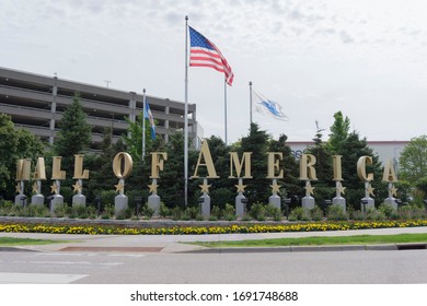 Bloomington, MN, USA, 2019-07-13: American Flag Blowing In Wind With Mall Of America Logo