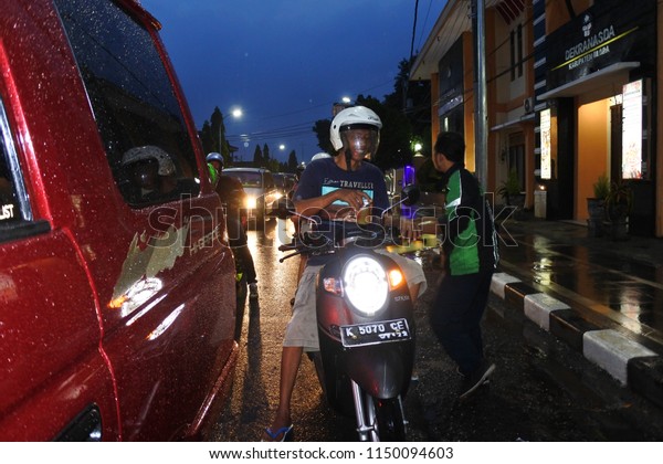 Blora-May 22, 2018:-association of Grab drivers\
Motorcycle share food during the holy month of Ramadhan, Central\
Java, Indonesia