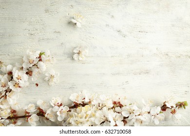 Blossoming branches on wooden background - Shutterstock ID 632710058
