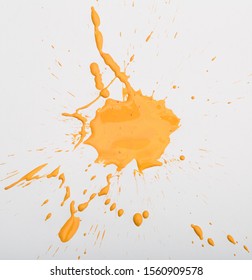 Blot and splashes of yellow paint isolated on white background - Shutterstock ID 1560909578