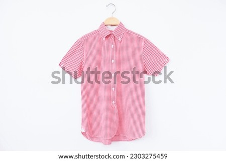ฺPink blouse with hanger wooden on background.