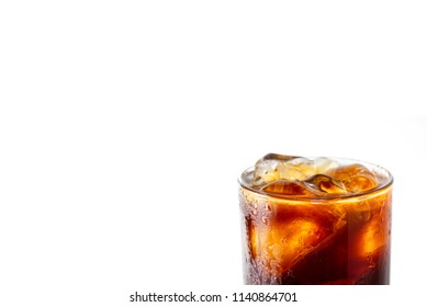 Blow Your Mind With Close Up Macro Photo Of Brew Coffee Americano With Ice In Glass Isolated On White Background. Water Drop On Americano Glass Make It Look Cold And Refreshing To Make You Thirsty.