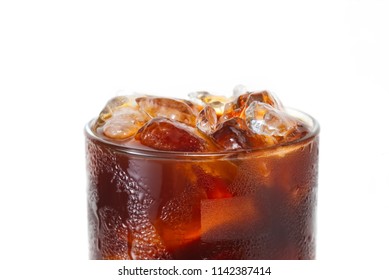 Blow Your Mind With Close Up Macro Photo Of Brew Coffee Americano With Ice In Glass Isolated On White Background. Water Drop On Americano Glass Make It Look Cold And Refreshing To Make You Thirsty.