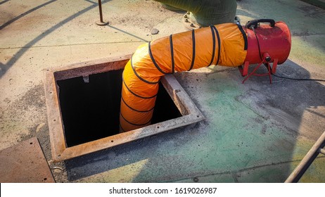 Blower With Ducting Blowing Air Into Confined Space Manhole Of Tank. Safety Equipment And One Of The Procedure Of Confined Space Entry.