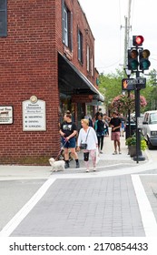 BLOWING ROCK, NC, USA-20 JUNE 2022: Two Woman And Dog Crossing Sunset Drive At Main St. Busy Sidewalk Behind.