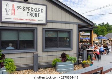 BLOWING ROCK, NC, USA-20 JUNE 2022: The Speckled Trout Restaurant And Bottle Shop, With Outside Dining.  Building, Sign And Customers.