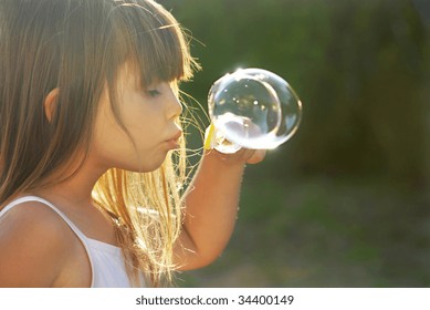 blowing soap bubbles