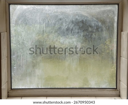 A blown double glazed window showing a misty appearance due to condensation forming on the inside of the panes.