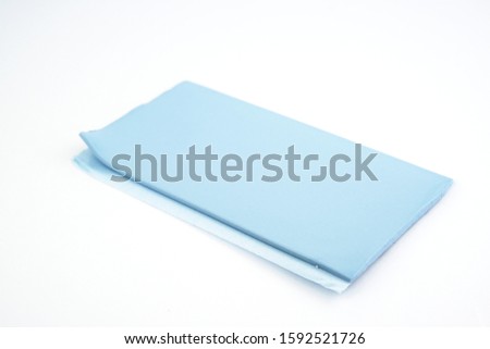 Blu Tack in a shape of thin flat strip. Selective focus. 