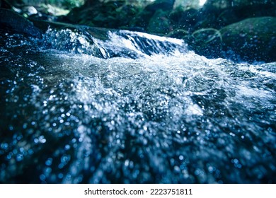 BLUBBLING WATER STREAM, FRESH BLUE BACKDROP, COLD WATER RIVER IN MOUNTAIN LANDSCAPE, NATURAL REFRESHING DESIGN - Shutterstock ID 2223751811