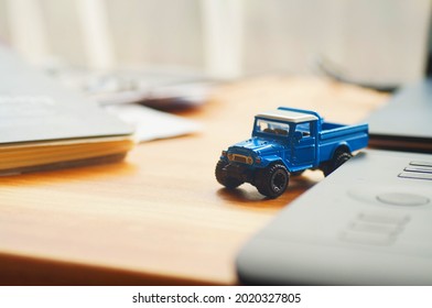 Blue 4x4 Ute Truck Model On The Office Desk.