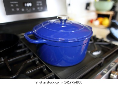 Blue 6 Quart Dutch Oven Resting On A Modern Natural Gas Stove.