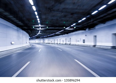 Blue Abstract Blurred Speed Motion In Urban Highway Road Tunnel, Moving Toward The Light