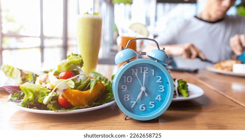 Blue alarm clock with IF (Intermittent Fasting) 16 and 8 diet rule and weight loss concept.-Diet plan concept - Shutterstock ID 2262658725