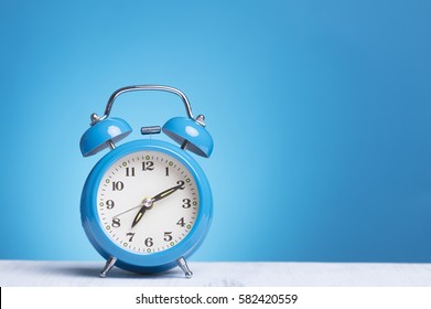 Blue Alarm Clock On Table