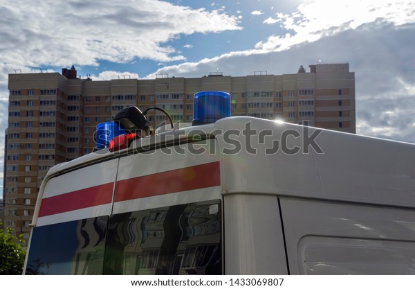 blue alarm
lights, emergency lights on white
car