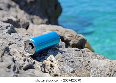 Blue Aluminum Beverage Can Left Behind On Stone Coast On Mediterriean, Problem Of Marine Pollution Of Inconsiderate People