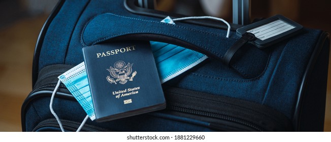 A Blue American Passport With A Blue Medical Mask On Top Of A Blue Suitcase