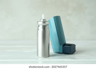 Blue Asthma Inhaler On White Wooden Table