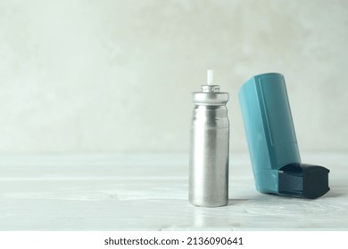 Blue Asthma Inhaler On White Wooden Table