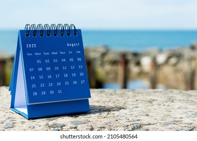 Blue August 2022 calendar on blurred background of blue ocean. 2022 New Year Concept