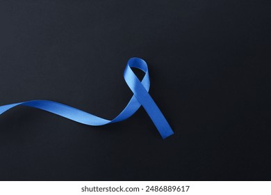 Blue awareness ribbon on black background, top view. Space for text - Powered by Shutterstock