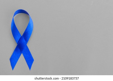 Blue Awareness Ribbon - Symbol For Fighting Prostate Cancer, Support The Survivors And Child Abuse Awareness. Isolated On White Background, Copy Space, Close Up, Top View, 