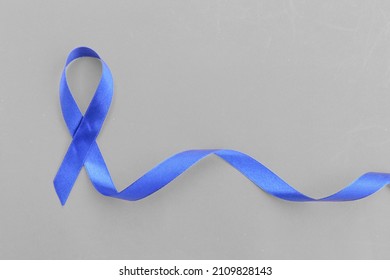 Blue Awareness Ribbon - Symbol For Fighting Prostate Cancer, Support The Survivors And Child Abuse Awareness. Isolated On White Background, Copy Space, Close Up, Top View, 