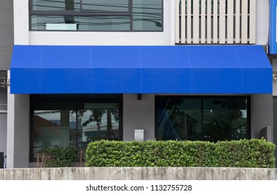 Blue Awning Over Glass Door Of Office