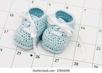 Blue Baby Booties On A Calendar Background, Baby Due Date