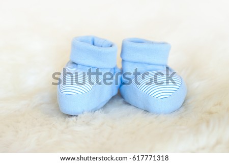 Blue baby newborn booties on white background