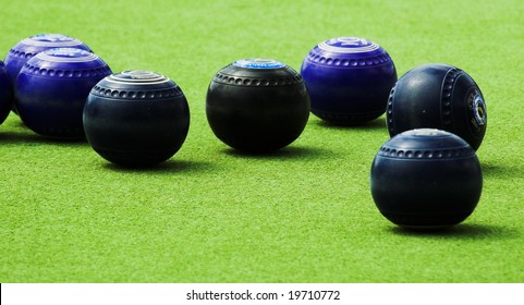 Blue And Back Lawn Bowls On An Artificial Bowling Green