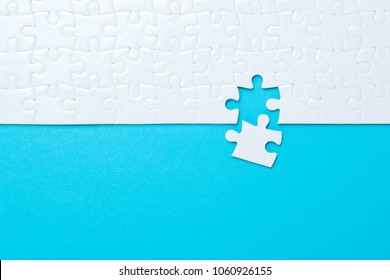 Blue background made from white puzzle pieces and place for your content