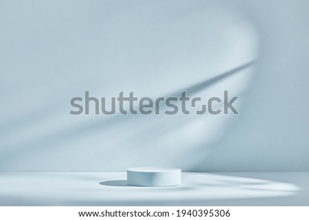 Blue background for product presentation with shadows and light. Empty round podium. Mockup.