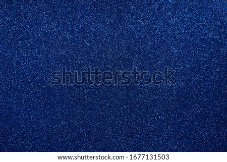 Blue background with sequins on it. Copy space. Trendy background. Festive backdrop for your projects.