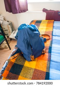 blue backpack rucksack on bed close up student; essex; england; uk