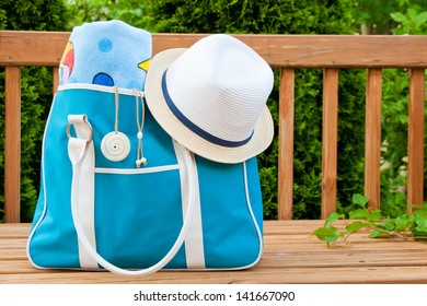 Blue Bag With Towel And Hat For Outdoor Pool Or Beach Weekend.