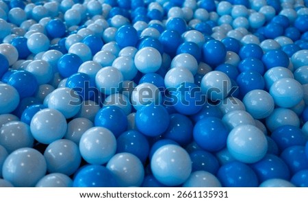 Blue ball pattern. Close up of plastic balls in a kids ball pool. Kids playground. Recreation and entertainment concept. Colorful kid blue ball. Colorful blue ball at the playground