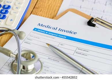 Blue Ballpoint Pen, A Chest Piece Of A Stethoscope And A Medical Invoice On A Clipboard. A Document Is Prepared By A Nurse And Some Blank Fields Is Waiting To Be Completed And Reviewed By A Patient.