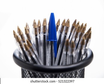 Blue ballpoint pens in black pencil case on white background