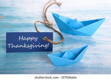 A Blue Banner With Happy Thanksgiving And Boats