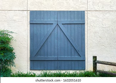 A Blue Barn Door On A White Stone Building