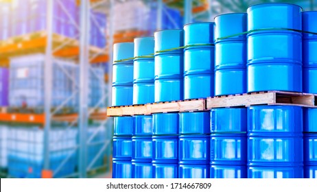 Blue barrels are stored in several levels. Concept - oil storage containers. Metal barrels as a symbol of oil production. Barrels in the warehouse of an oil refinery. Crude petroleum in stock.