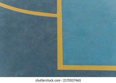 Blue Basketball Or Futsal Court With Yellow Lines. Closed Overhead View Of A Piece Of The Blue Sports Court. Sport Concept.