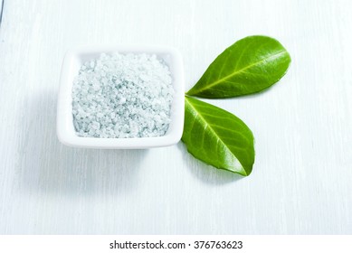 blue bath salt on old white wood table
