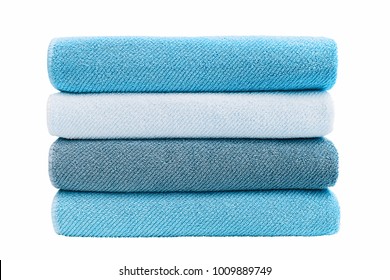 Blue bath towels in stack. Isolated over white background.