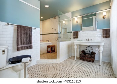 Blue Bathroom Interior With White Tile Trim Wall, White Sink And Bath Tub. Northwest, USA